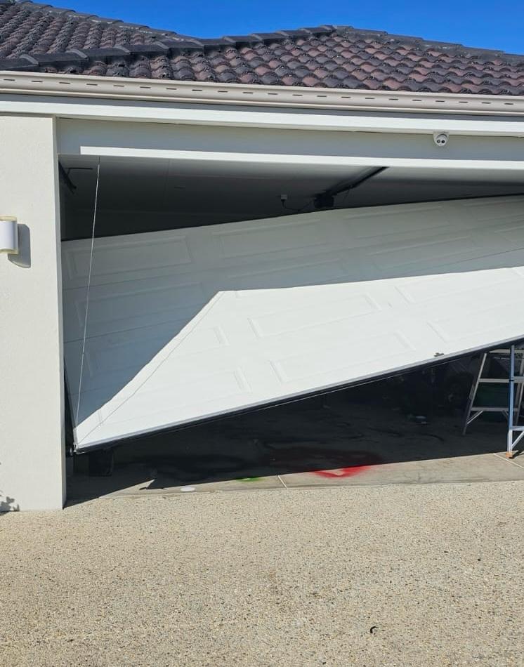Garage door off track before repair - emergency situation
